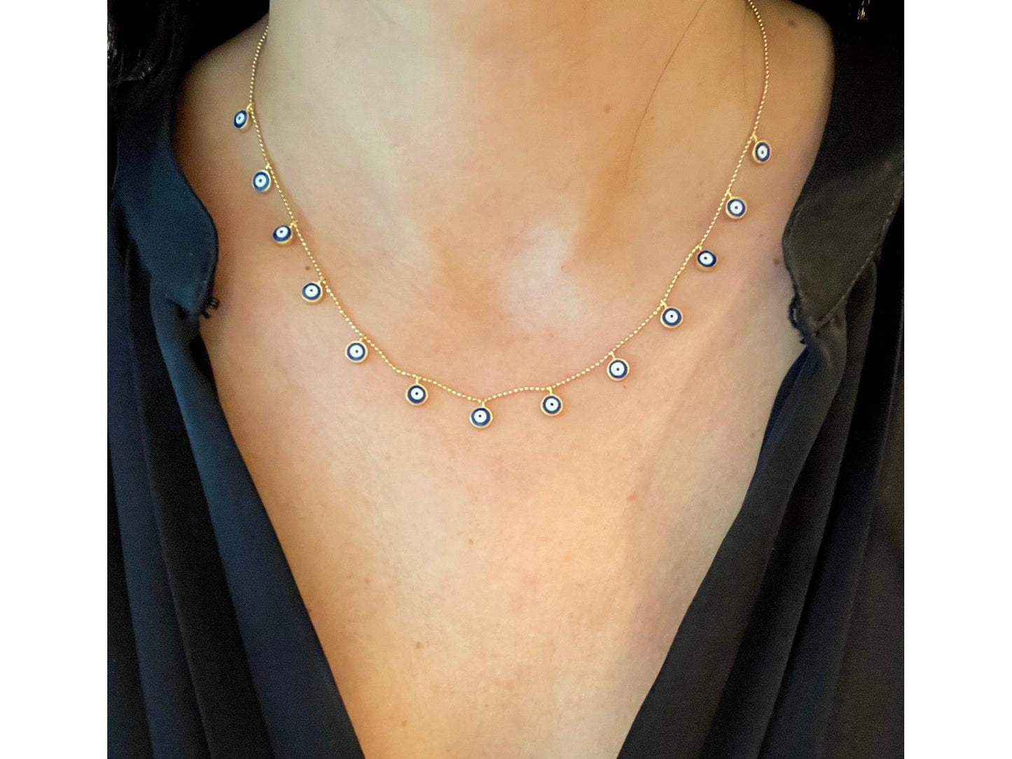 Necklace with dangly evil eyes